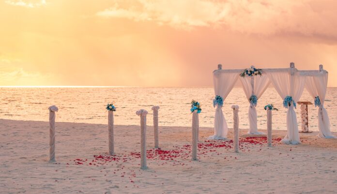 lovely-warm-sunset-romantic-wedding-arch-setup